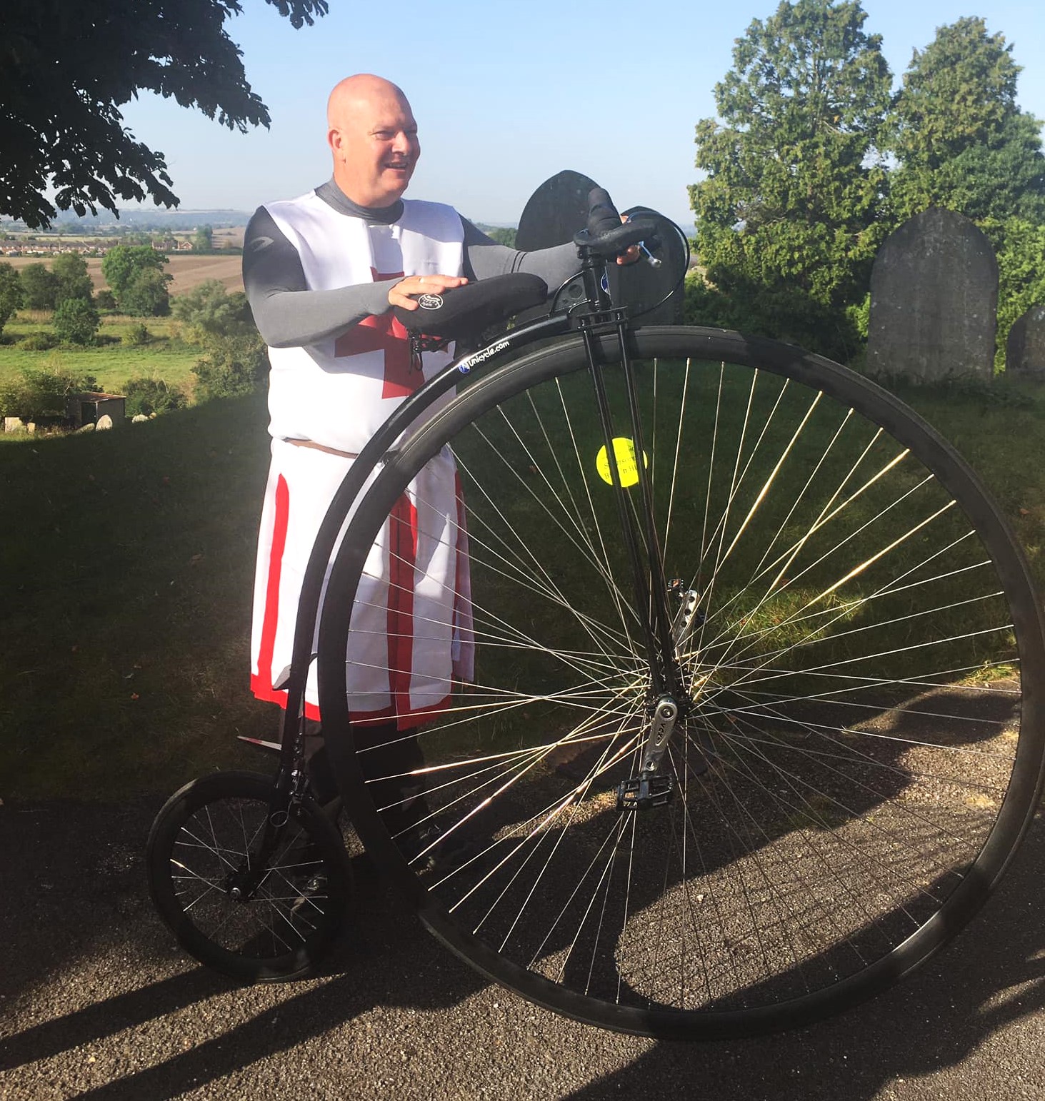 man in costume with penny farthing bike