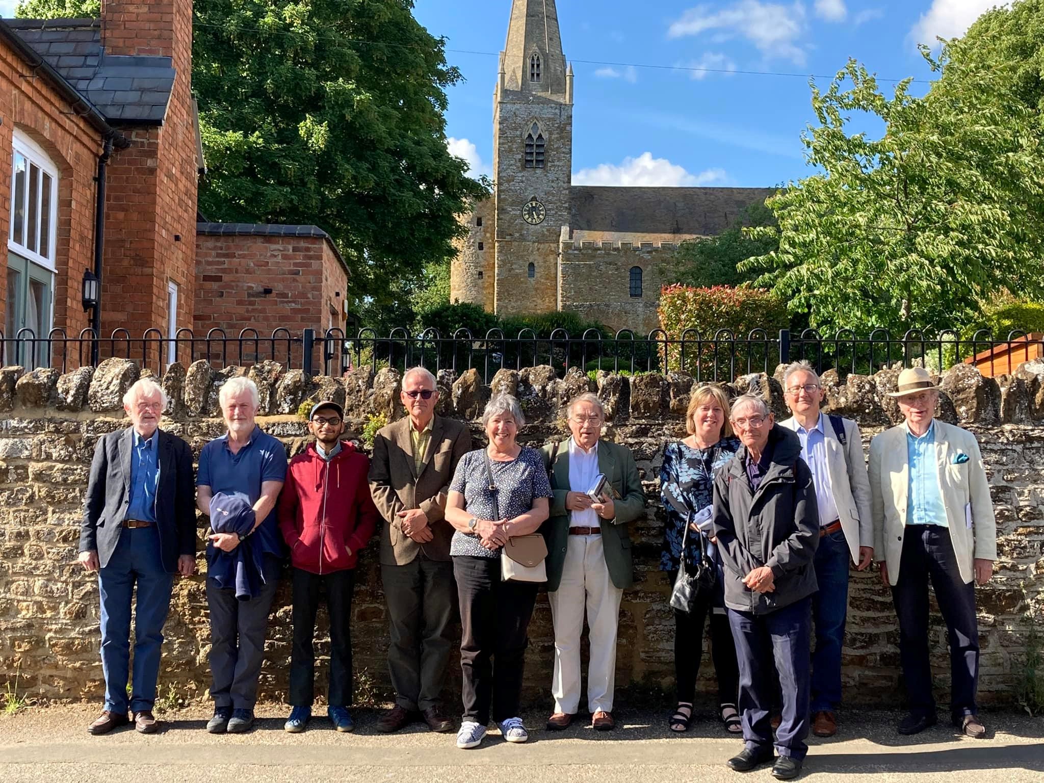 people stand in front of a church